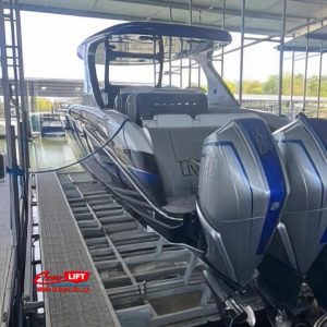 Rear angle view of a sleek boat with triple outboard engines on a 26,000 lb Econo Lift.